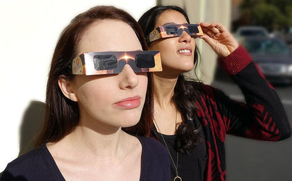 Two people looking at the sun through Lunt eclipse glasses